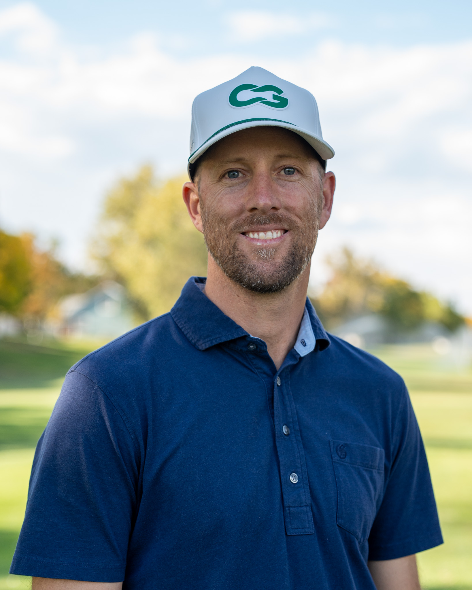 Mike Weingartner smiling and looking into the camera on a golf course.