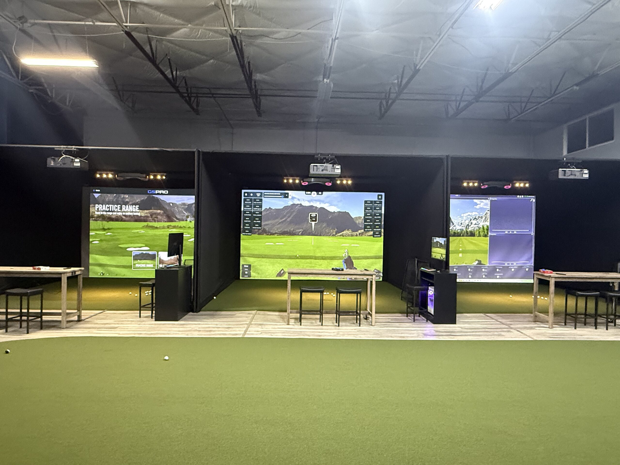 Large simulator bays at an indoor golf course.